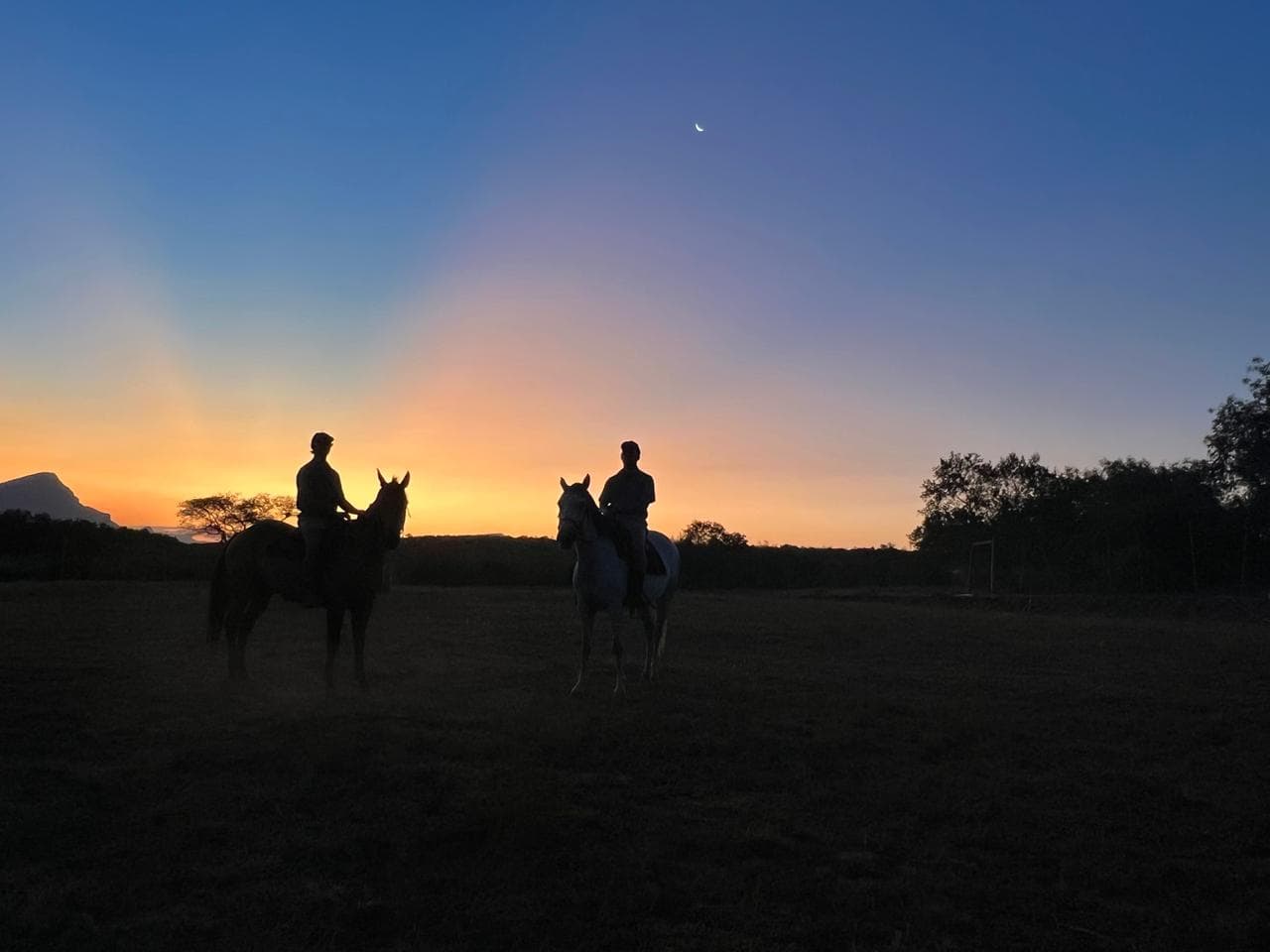 Riders silhouetted at sunset in the lowveld