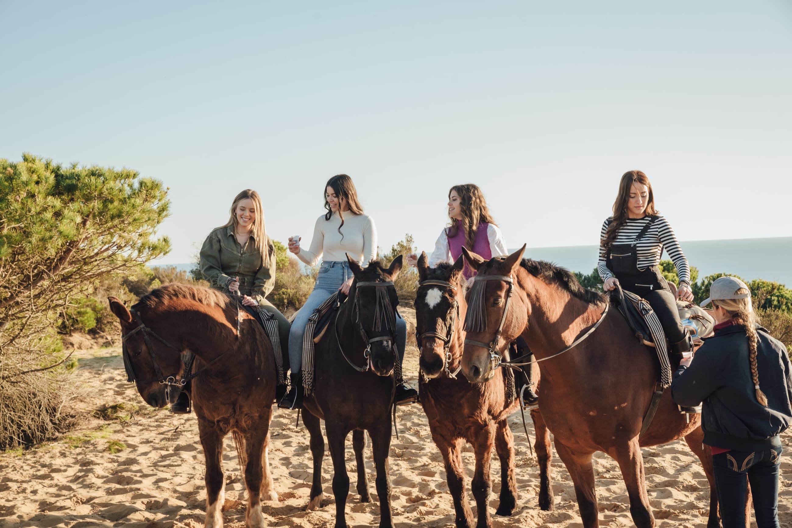 Friends pausing in a field after riding