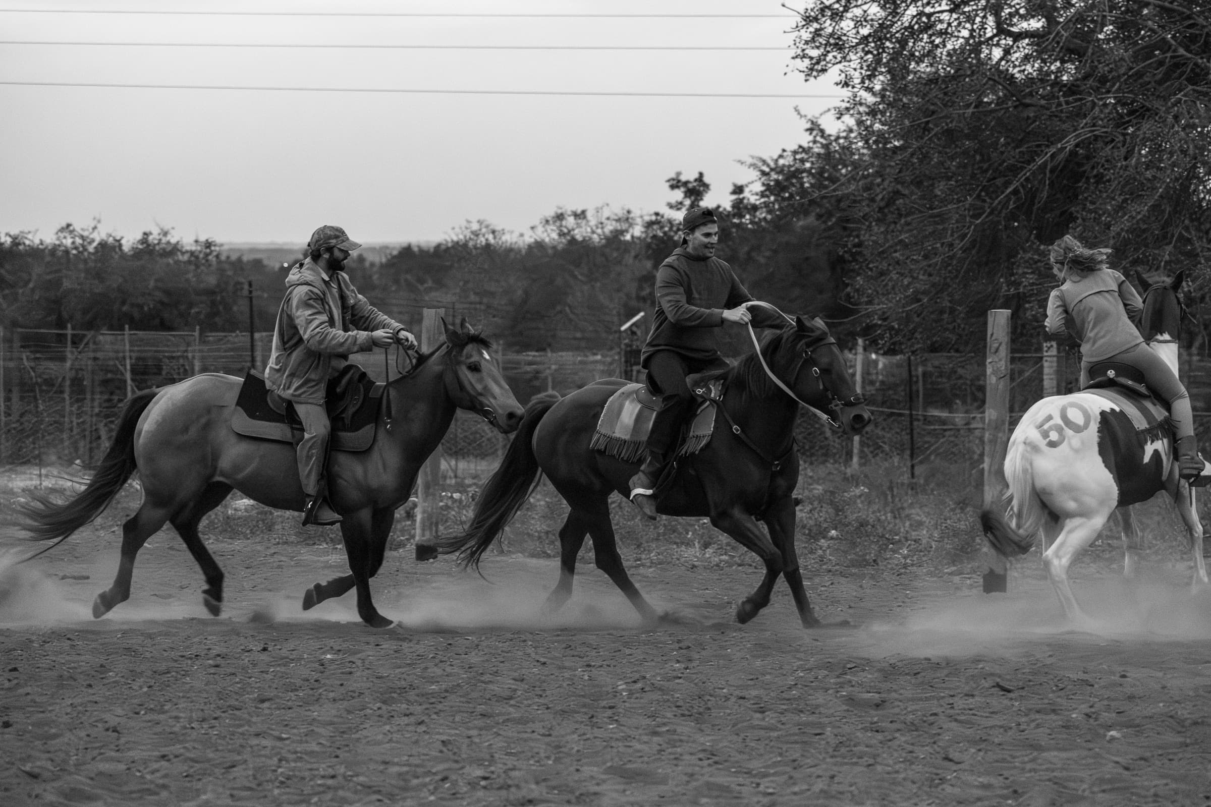 Riders moving together through dust
